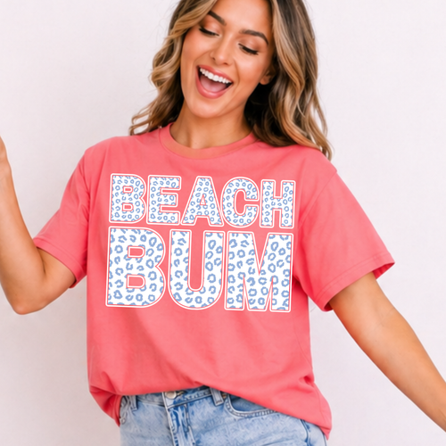 Woman wearing a pink 'Beach Bum' t-shirt against a plain background