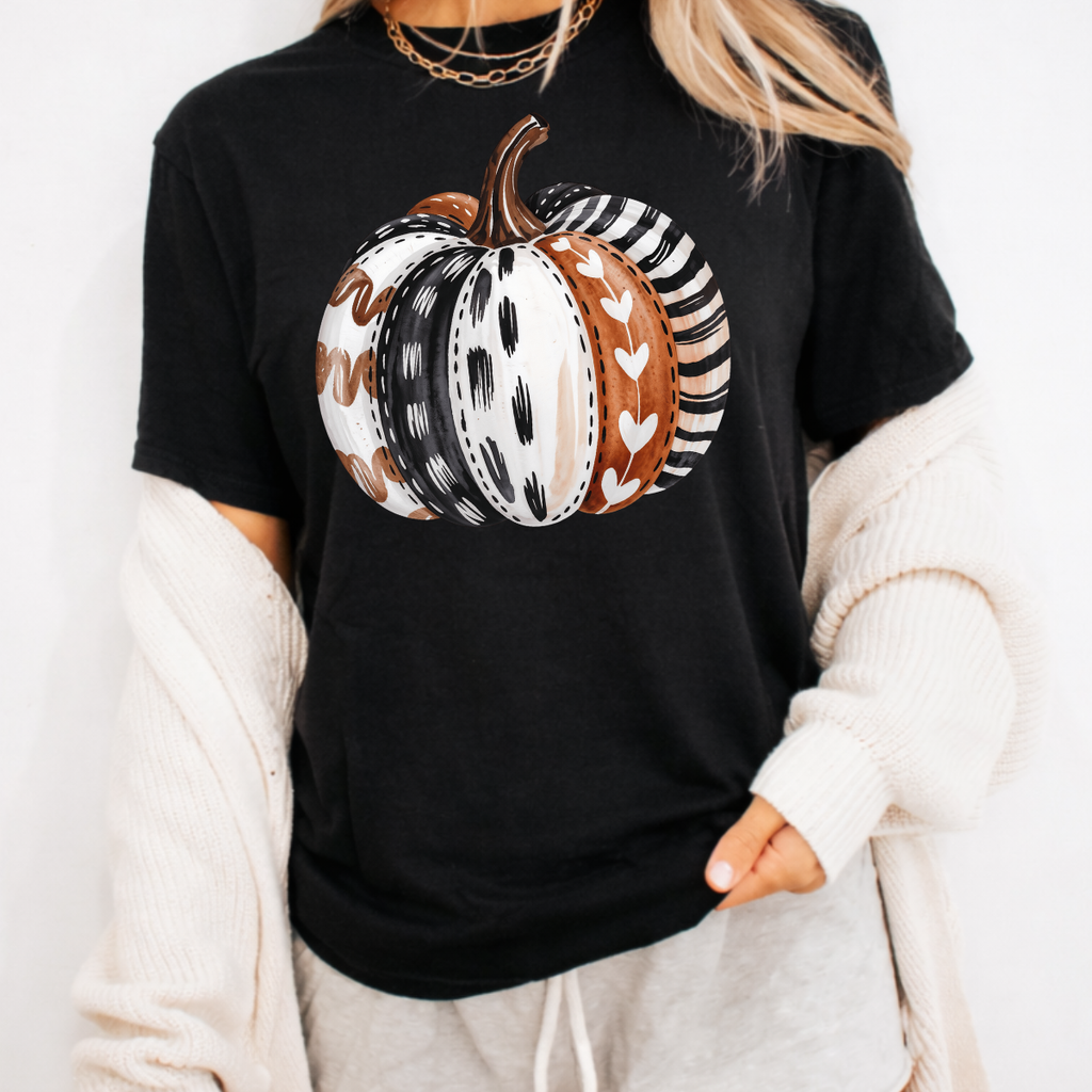 Woman wearing a black patterned boho pumpkin fall graphic tee with a neutral boho pumpkin design