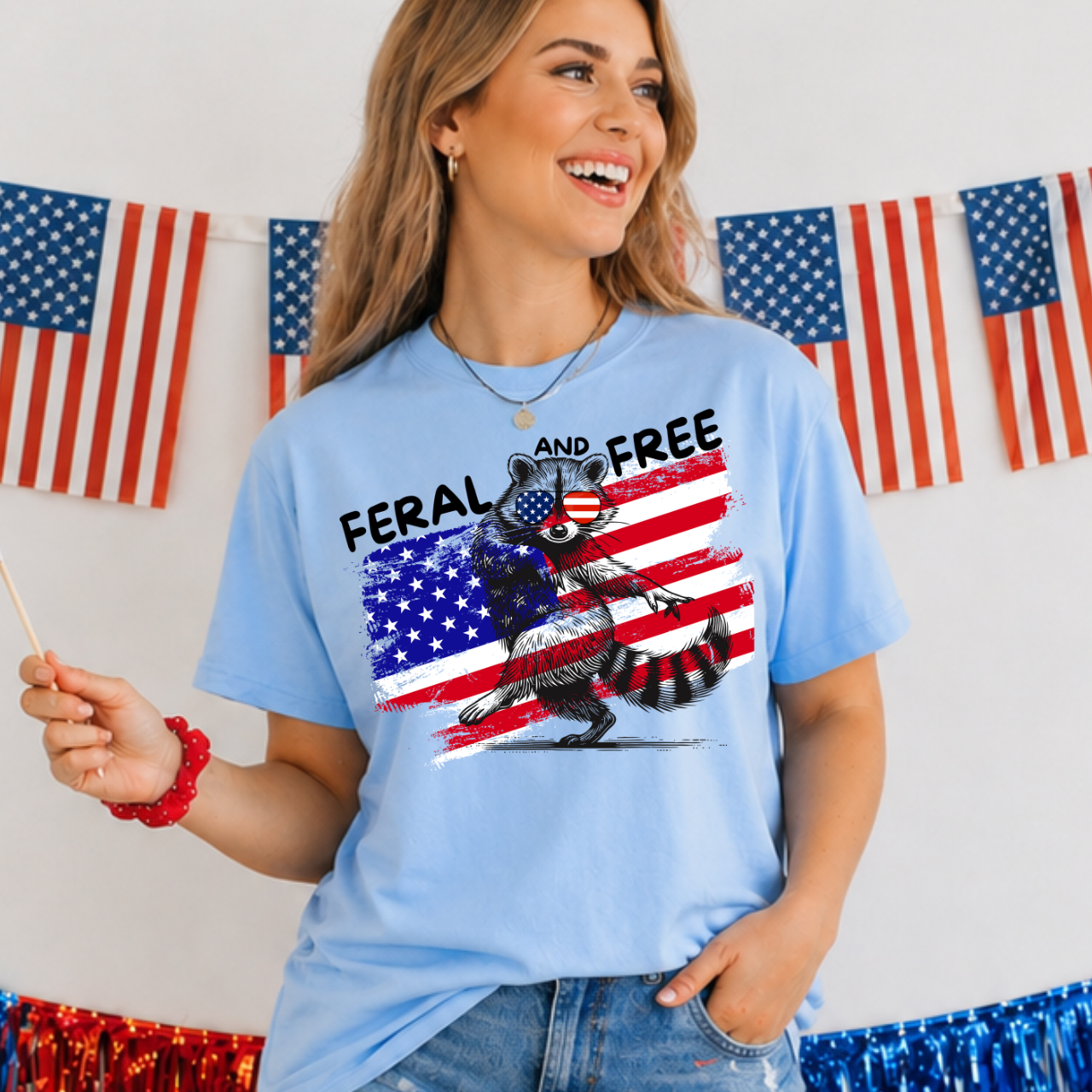 Woman wearing a blue t-shirt with a graphic design in front of American flags.