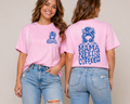 Two women wearing pink t-shirts with 'Mama Needs Coffee' text, standing side by side against a plain background.