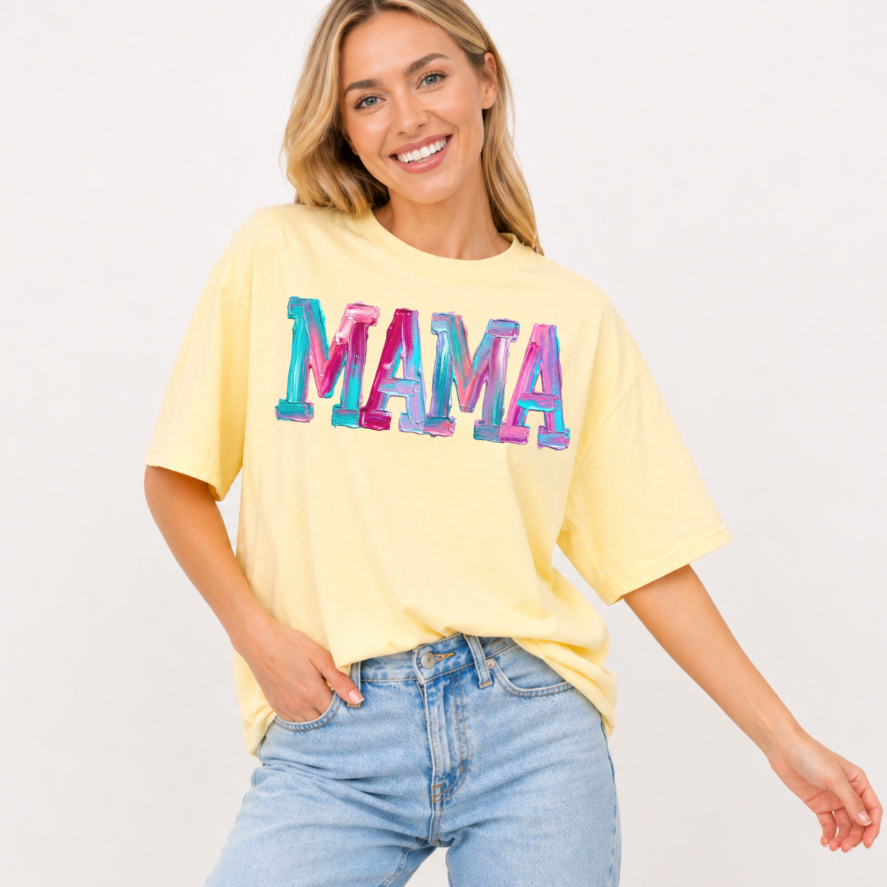 Woman wearing a yellow t-shirt with 'MAMA' in colorful letters on a plain background