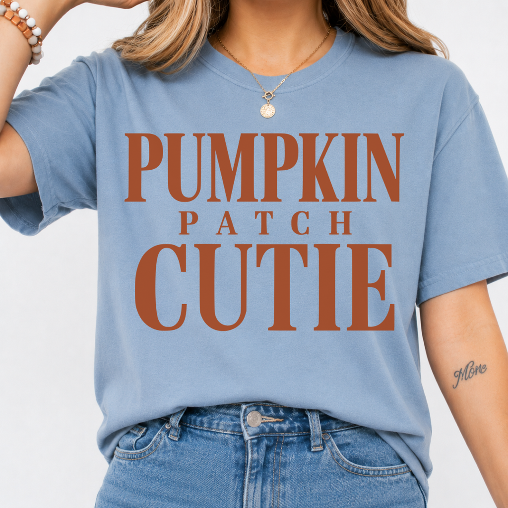 Woman wearing a stone blue Pumpkin Patch Cutie fall graphic tee with rust orange lettering.