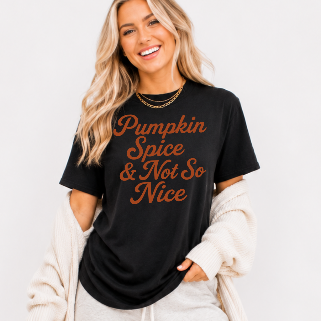 Woman wearing a black Pumpkin Spice and Not So Nice fall graphic tee with rust orange script lettering.