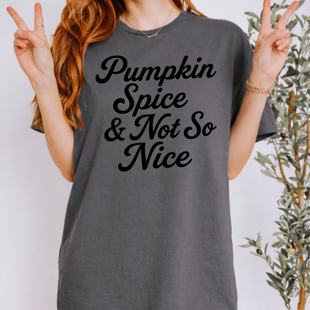 Woman wearing a charcoal Pumpkin Spice and Not So Nice fall graphic tee with rust orange script lettering.