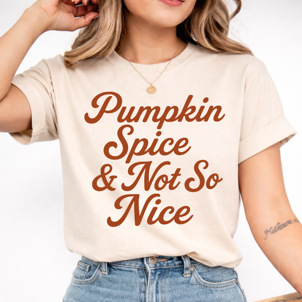 Woman wearing a sand Pumpkin Spice and Not So Nice fall graphic tee with rust orange script lettering.