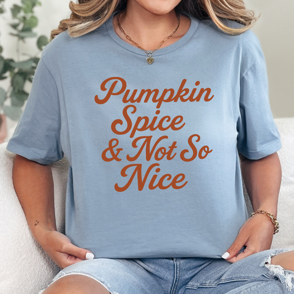 Woman wearing a stone blue Pumpkin Spice and Not So Nice fall graphic tee with rust orange script lettering.