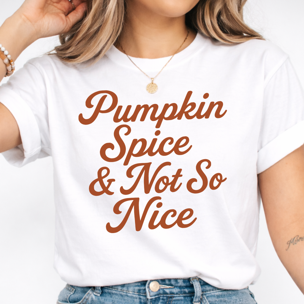 Woman wearing a white Pumpkin Spice and Not So Nice fall graphic tee with rust orange script lettering.