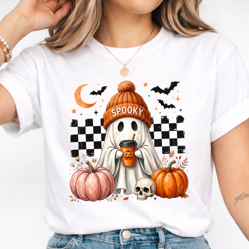 Woman wearing a white spooky ghost pumpkin coffee graphic tee with pumpkins, bats, and a ghost