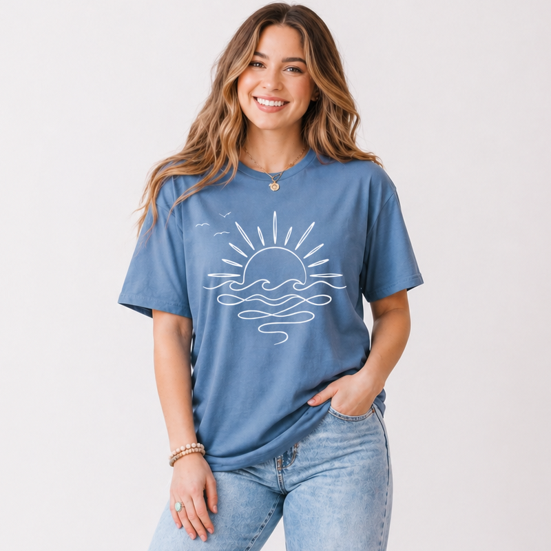 Woman wearing a blue graphic t-shirt and distressed jeans on a white background