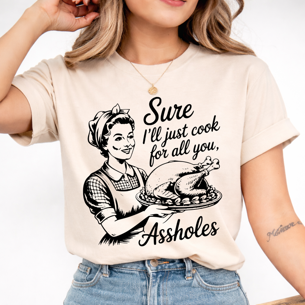 Woman wearing a sand funny Thanksgiving graphic tee with a retro hostess holding a roasted turkey.