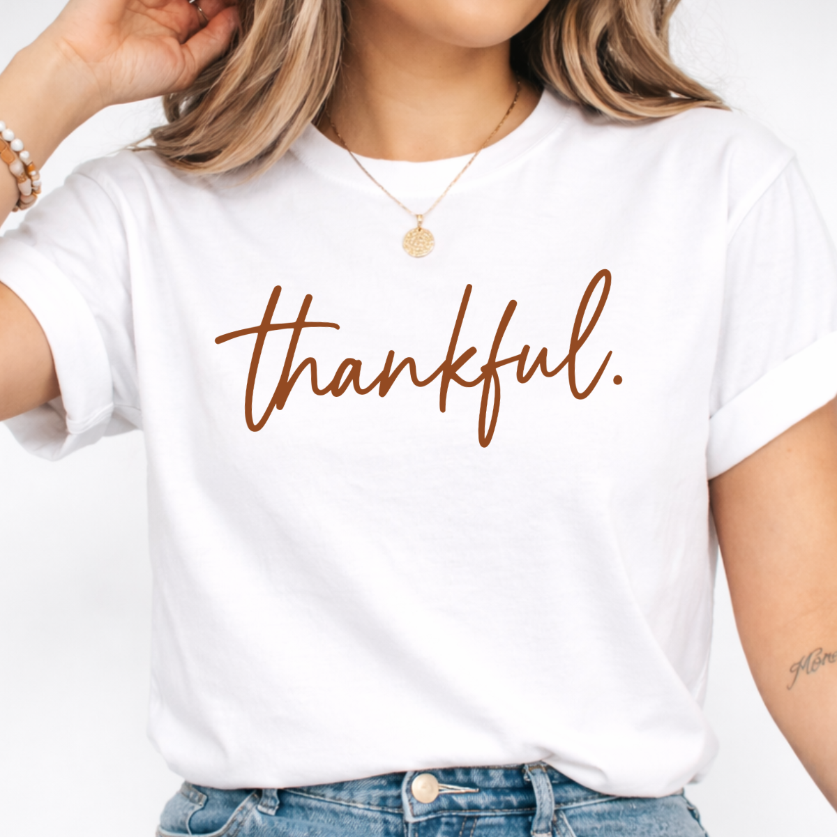 Shop this Thankful Thanksgiving graphic tee for women, featuring warm brown script on a classic tee for Friendsgiving, fall gatherings and holiday outfits.